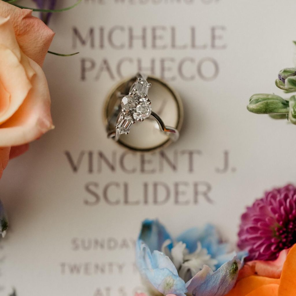 A showcase of the engagement ring of Michelle Pacheco with colorful flowers as decorations.