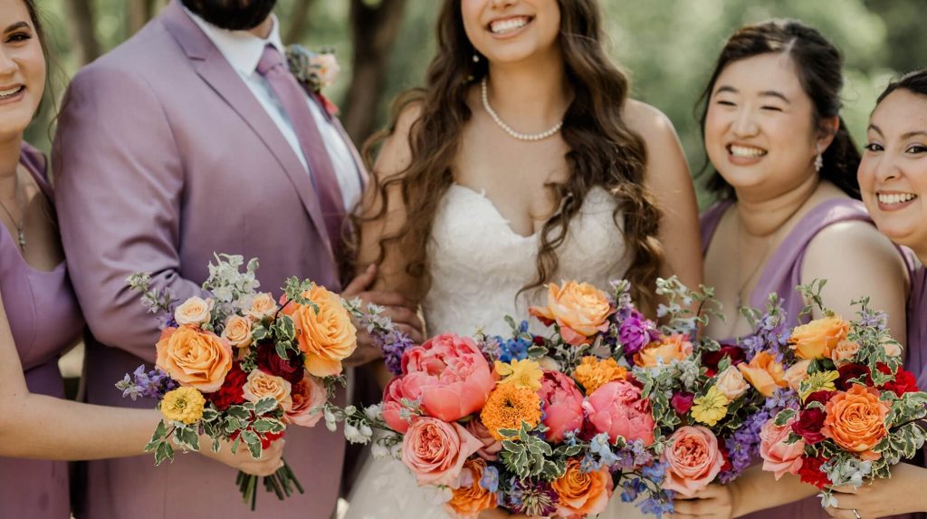 A portrait of the groom and bride together with their bridesmaids.